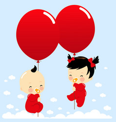 Asian Twin Babies Holding Balloons