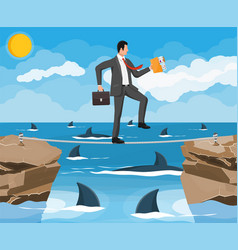 Businessman Walking A Tightrope Over Shark In Sea