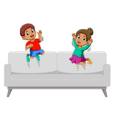 Happy Boy And Girl Jumping On Sofa