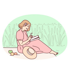 Woman Sitting In Field Reading Book