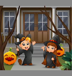 Happy Witch Couple Standing In Front Of The House