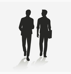 Silhouette Of Two Men Walking While Chatting