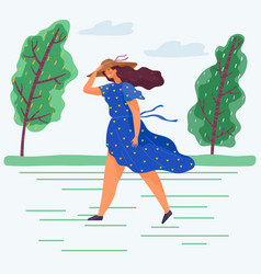 Young Woman Walking In Windy Weather Through Park