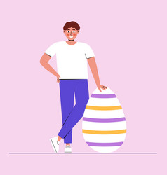 Man Stands Near Large Easter Egg