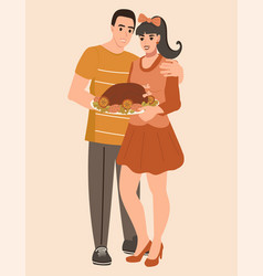 Young Family Man And Woman Holding A Turkey