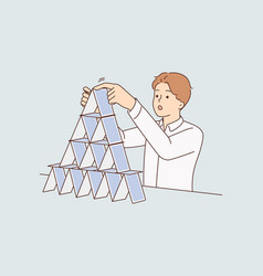 Concentrated Man Makes Pyramid Of Playing Cards