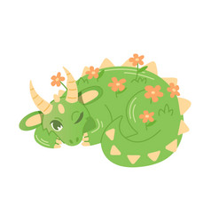 Large Green Dragon Covered With Flowers Lies