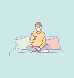 Smiling Young Man Sitting Watching Tv Holding