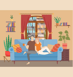 Couple Sitting On Sofa Cuddling And Drinking Tea