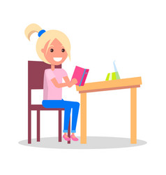 Profile Of Smiling Girl Sitting At Desk With Book