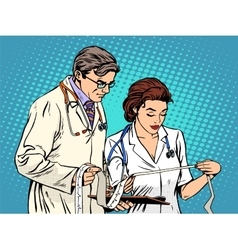 Doctor And Nurse Looking Cardiogram