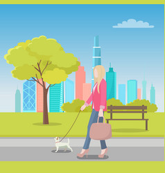 Blonde Woman Walking With Dog In City Park