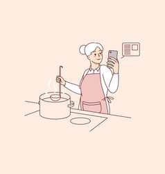 Elderly Woman Cooking With Recipe On Cellphone