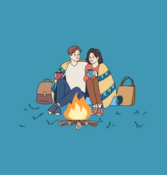 Happy Couple Sit Near Fire On Romantic Date