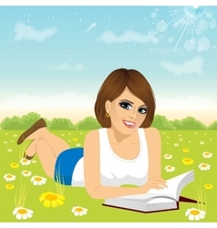 Woman Lying Down On Grass Reading Book