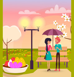 Couple Under Umbrella In Park Near Streetlight