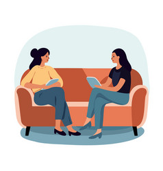 Two Women Dressed Casually Sitting On A Sofa