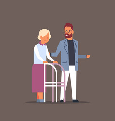 Man Helping Senior Woman With Walking Frame