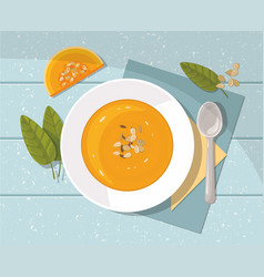 Pumpkin Soup With Spoon On Blue Top View