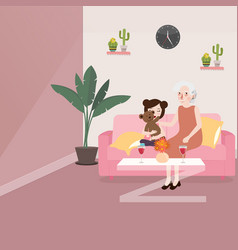 Grandma With Her Grand Daughter Sitting In Sofa