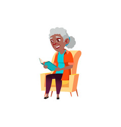 Old African Lady Sitting On Armchair And Reading