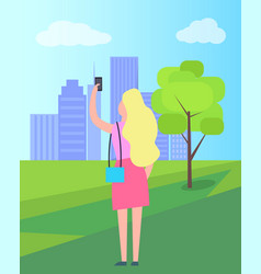 Woman Taking Selfie In City Park