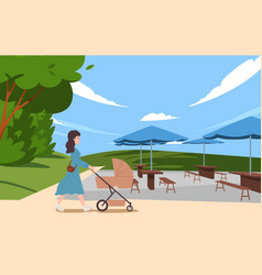 Smiling Woman Walking With Baby Carriage At Park