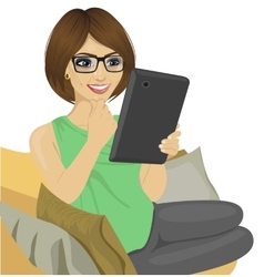 Young Woman Reading E-book On The Sofa