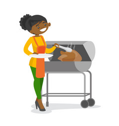 African Woman Cooking Chicken On The Barbecue