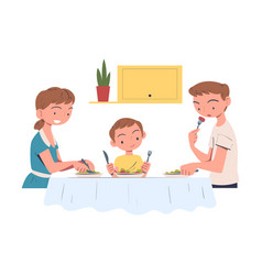 Family In The Kitchen Sitting At Table And Eating