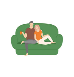 Couple Sitting And Cuddling On Sofa At Home