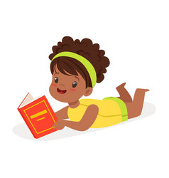 Sweet African Girl Lying On The Floor And Reading