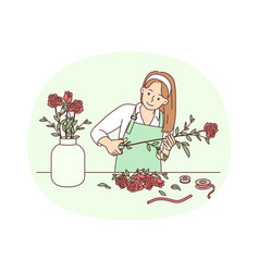 Female Florist Working With Flowers In Workshop