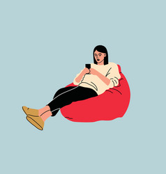 Woman Sitting On Sofa Pouf Holds Smartphone In Her