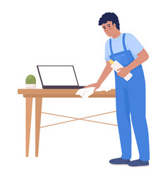 Male Housekeeper Wiping Wood Table With Laptop