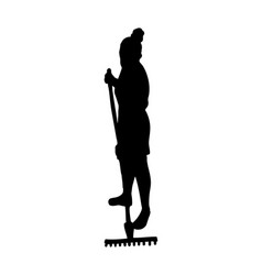 Silhouette Of A Woman With A Rake