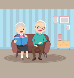 Happy Elderly Reading Book Together On Sofa