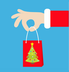 Santa Claus Hand Holding Gift Shopping Paper Bag