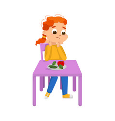 Cute Boy Sitting At Table And Eating Vegetables