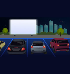 Cars Watch A Movie In An Open Parking Lot At Night