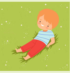 Smiling Boy Lying Down On Green Lawn Cute Kid