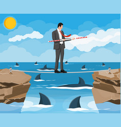 Businessman Walking A Tightrope Over Shark In Sea