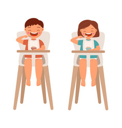 Toddler Boy And Girl Eat In A High Chair