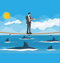 Businessman Walking A Tightrope Over Shark In Sea