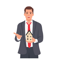 Young Business Man Holding Home Model