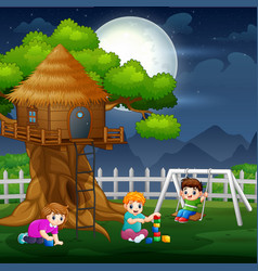 Happy Kids Playing Around Tree House At Night