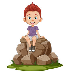 Smiling Boy Perched Atop A Pile Of Rocks