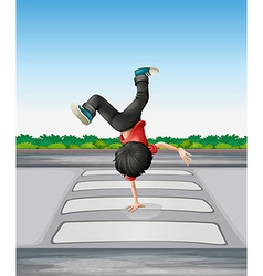 A Boy Breakdancing At The Pedestrian Lane