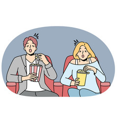 Couple Eat Popcorn Sitting In Cinema