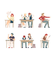 Teenage School Students Sitting At Desk In